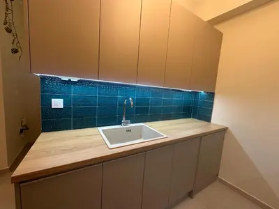a kitchen counter with a sink and blue tiles at Kiafas 5 Apartment Athens in Athens