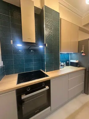 a kitchen with white cabinets and a stove top oven at Kiafas 5 Apartment Athens in Athens