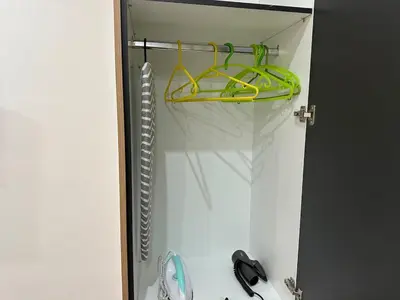 a shower with a yellow hanger in a bathroom at Brown balcony suite no 2 Piraeus Port in Piraeus