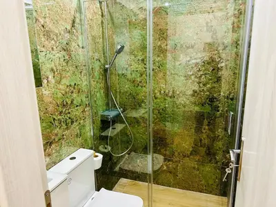 a bathroom with a glass shower with a toilet at Brown balcony suite no 2 Piraeus Port in Piraeus