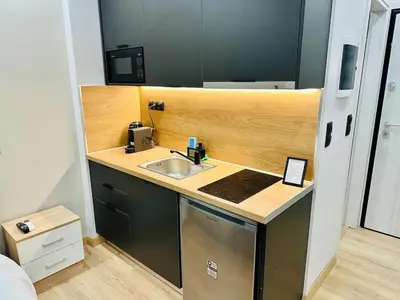 a small kitchen with a sink and a stove at Brown balcony suite no 2 Piraeus Port in Piraeus
