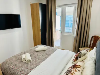 a bedroom with a bed with towels on it at Brown balcony suite no 2 Piraeus Port in Piraeus