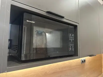 a microwave oven sitting on top of a counter at Brown balcony suite no 2 Piraeus Port in Piraeus