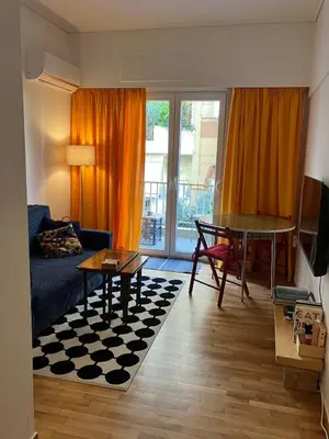 a living room with a couch and a table at Sweet Home Athens in Athens