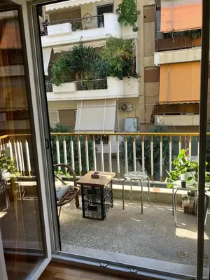 a view of a balcony with a table and chairs at Sweet Home Athens in Athens