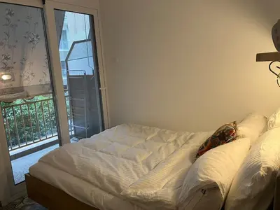 a white bed in a room with a window at Sweet Home Athens in Athens