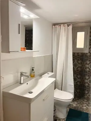 a white bathroom with a sink and a toilet at Sweet Home Athens in Athens