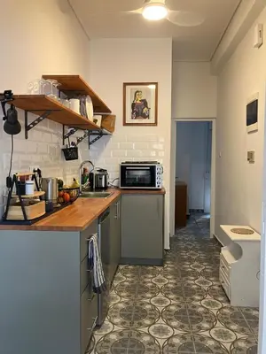 a kitchen with a counter and a microwave at Sweet Home Athens in Athens