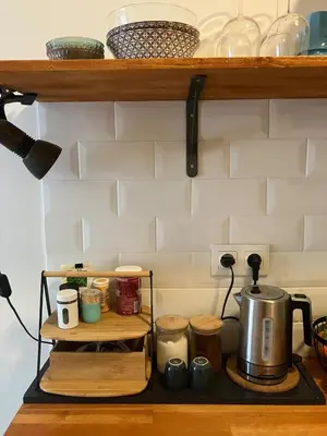 a kitchen counter with a tea pot on a shelf at Sweet Home Athens in Athens
