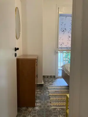 a room with a mirror and a dresser and a window at Sweet Home Athens in Athens