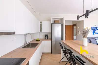 a kitchen with white cabinets and a wooden counter top at Sky-High Athenian Elegance Retreat With Views! in Athens