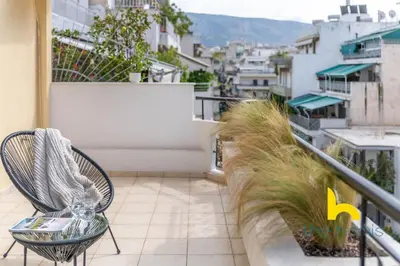 a balcony with a bench and chairs on a balcony at Sky-High Athenian Elegance Retreat With Views! in Athens