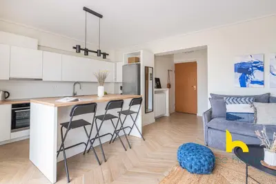 a kitchen and a living room with a table and chairs at Sky-High Athenian Elegance Retreat With Views! in Athens