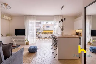 a kitchen and a living room with a table at Sky-High Athenian Elegance Retreat With Views! in Athens