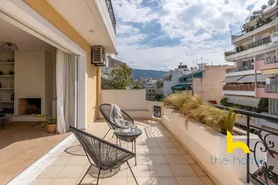 a balcony with chairs and a view of a city at Sky-High Athenian Elegance Retreat With Views! in Athens