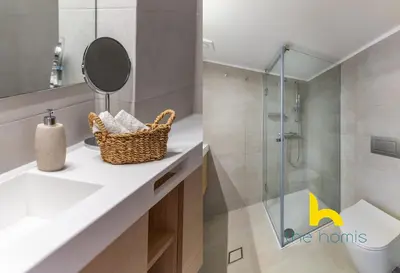 a bathroom with a sink and a glass shower at Sky-High Athenian Elegance Retreat With Views! in Athens
