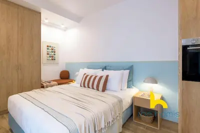 a bedroom with a large bed and a television at Stylish Love Nest W Balcony in Heart of Koukaki! in Athens