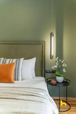a bedroom with a bed and a side table with aarijuanaarijuana at Top-Floor Oasis, King-Bed & Whirlpool, Acropolis! in Athens