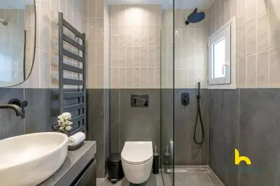 a bathroom with a sink and a toilet and a shower at Top-Floor Oasis, King-Bed & Whirlpool, Acropolis! in Athens