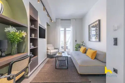 a living room with a couch and a table at Top-Floor Oasis, King-Bed & Whirlpool, Acropolis! in Athens