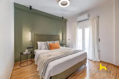a bedroom with a large bed with a green wall at Top-Floor Oasis, King-Bed & Whirlpool, Acropolis! in Athens