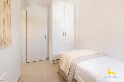 a white bedroom with a bed and a closet at Rooftop Hideaway w Large Private Patio near Metro in Athens
