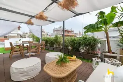 a patio with a table and chairs and an umbrella at Rooftop Hideaway w Large Private Patio near Metro in Athens