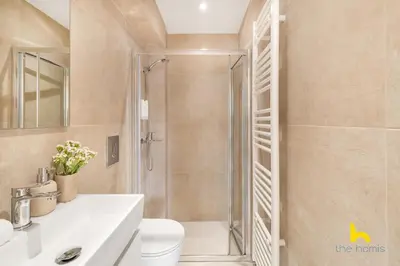a bathroom with a shower and a toilet and a sink at Rooftop Hideaway w Large Private Patio near Metro in Athens