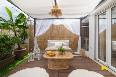 a patio with a table and a couch on a balcony at Rooftop Hideaway w Large Private Patio near Metro in Athens