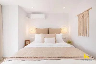 a bedroom with a large white bed with white pillows at Rooftop Hideaway w Large Private Patio near Metro in Athens