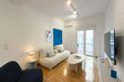 a living room with a couch and a table at Ella's Athenian Home in Athens
