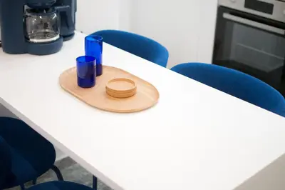 a hat sitting on a table with blue chairs at Ella's Athenian Home in Athens