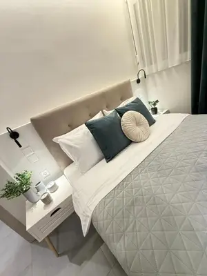 a bedroom with a large bed with pillows on it at Smyrni Cozy Luxury in Athens