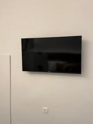 a flat screen tv hanging on a white wall at Smyrni Cozy Luxury in Athens