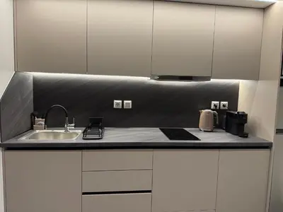 a kitchen with white cabinets and a sink at Smyrni Cozy Luxury in Athens