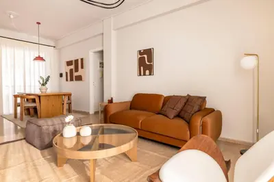 a living room with a couch and a table at Chalandri Bright 2BR Apartment by UPSTREET in Athens