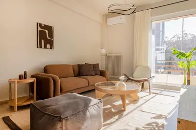 a living room with a couch and a table at Chalandri Bright 2BR Apartment by UPSTREET in Athens