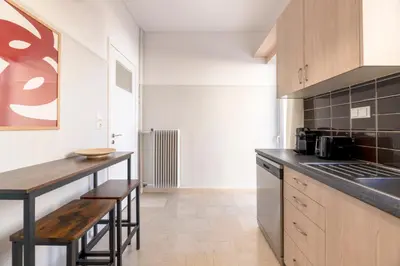 a kitchen with a wooden counter top and a table at Chalandri Bright 2BR Apartment by UPSTREET in Athens