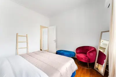 a bedroom with a bed and a mirror and a chair at Boutique 5BDT-3 ΒATH Apt with Eclectic Style- Acropolis in Athens