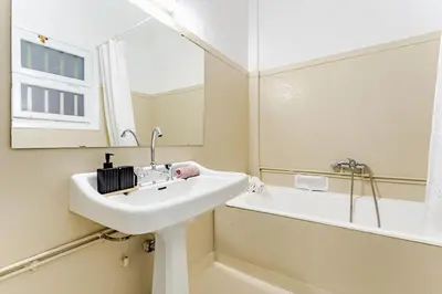 a bathroom with a sink and a tub and a mirror at Boutique 5BDT-3 ΒATH Apt with Eclectic Style- Acropolis in Athens