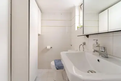 a white bathroom with a sink and a toilet at Amazing Luxurious BrandNew 4BDR 2Bath ΑcropolisAPT in Athens