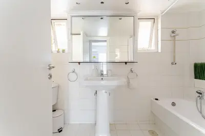 a white bathroom with a sink and a bath tub at Amazing Luxurious BrandNew 4BDR 2Bath ΑcropolisAPT in Athens