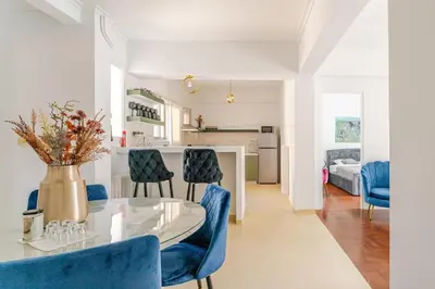 a kitchen and living room with a table and chairs at Amazing Luxurious BrandNew 4BDR 2Bath ΑcropolisAPT in Athens