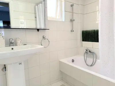 a white bathroom with a sink and a bath tub at Amazing Luxurious BrandNew 4BDR 2Bath ΑcropolisAPT in Athens