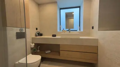 a bathroom with a sink and a toilet and a mirror at Myronos suite with jacuzzi in Piraeus
