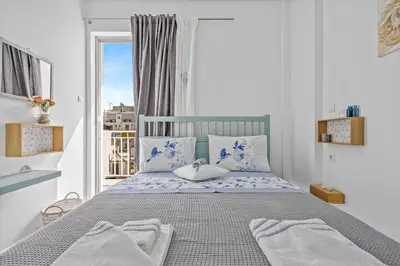 a bedroom with a bed with towels on it at h2h Levandre Kallithea near Metropolitan, in Athens
