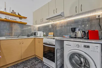 a kitchen with a washing machine and a washer at h2h Levandre Kallithea near Metropolitan, in Athens