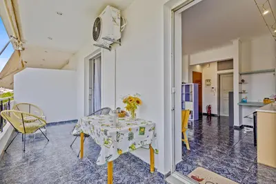 a dining room with a table with flowers on it at h2h Levandre Kallithea near Metropolitan, in Athens