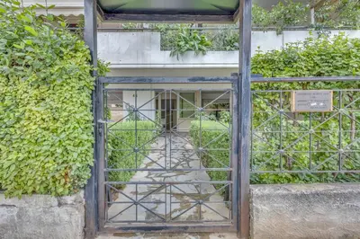 an open gate in front of a building at h2h Levandre Kallithea near Metropolitan, in Athens
