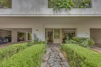 a stone walkway in front of a house with bushes at h2h Levandre Kallithea near Metropolitan, in Athens